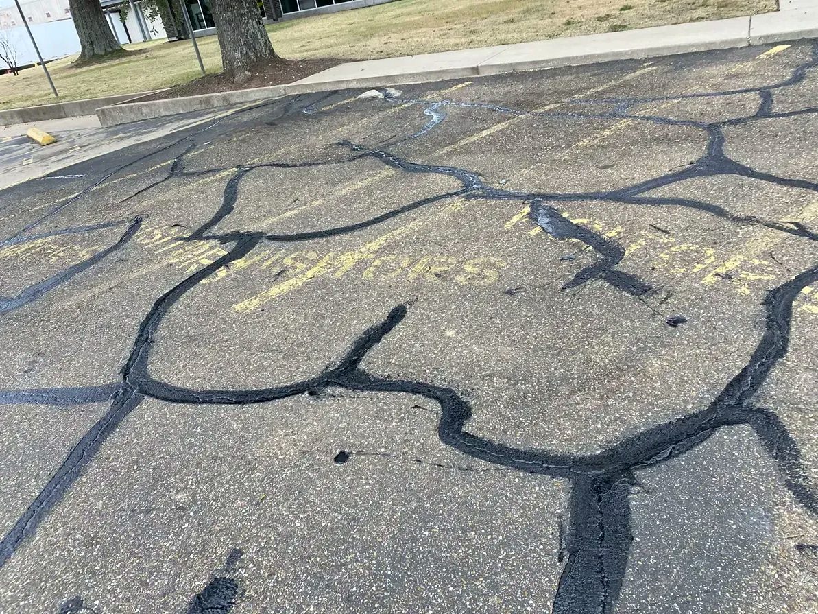 Parking lot repaired with hot rubber crack filler