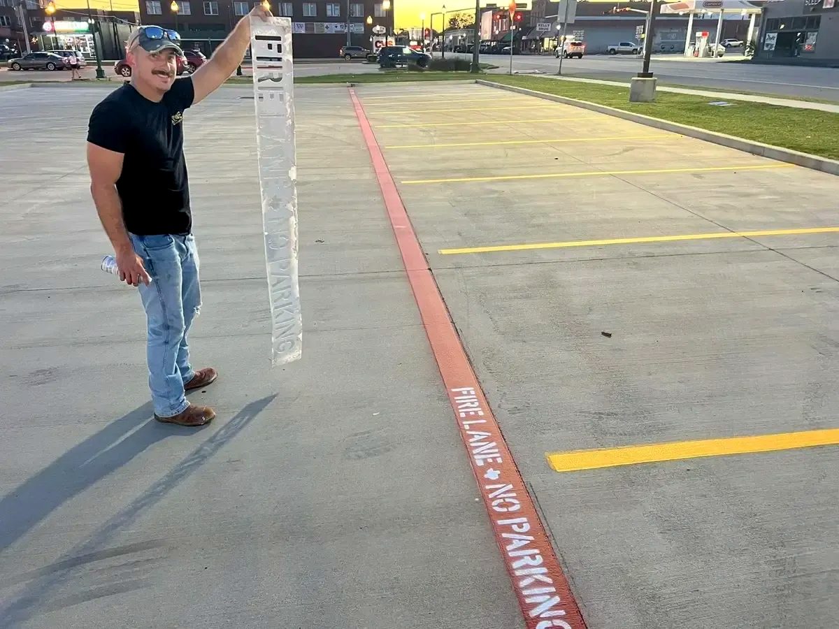 Ace crew member after completing fire lane striping in Mineola, TX